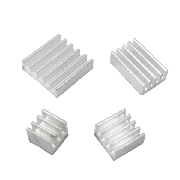 Four metallic heat sinks on a light gray background